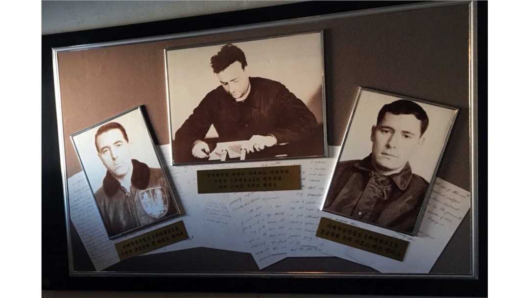 FILE - Grainy, black-and-white photos of the captain and captured crew hang in the USS Pueblo in Pyongyang, North Korea, Jan. 24, 2018.