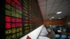 Investors look at computer screens showing stock information at a brokerage house in Shanghai, China, April 21, 2016.
