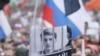 A supporter of student and blogger Yegor Zhukov, who was detained during a recent protest for fair elections, holds a placard during a rally to demand authorities allow opposition candidates to run in the local election in Moscow, Russia.